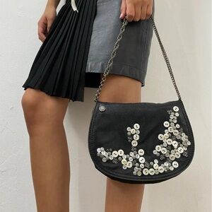 Italian brand black shoulder bag with decorative buttons on the front